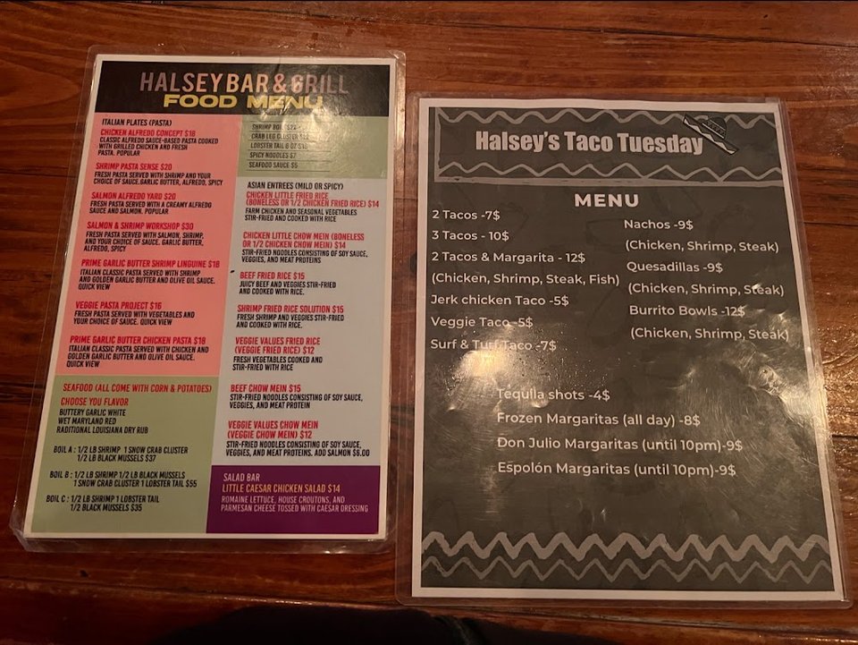 Menu board with wings, bowls, and seafood.
